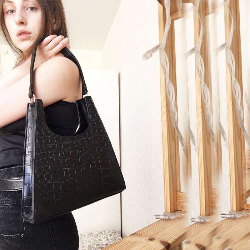 sac à main façon croco noir